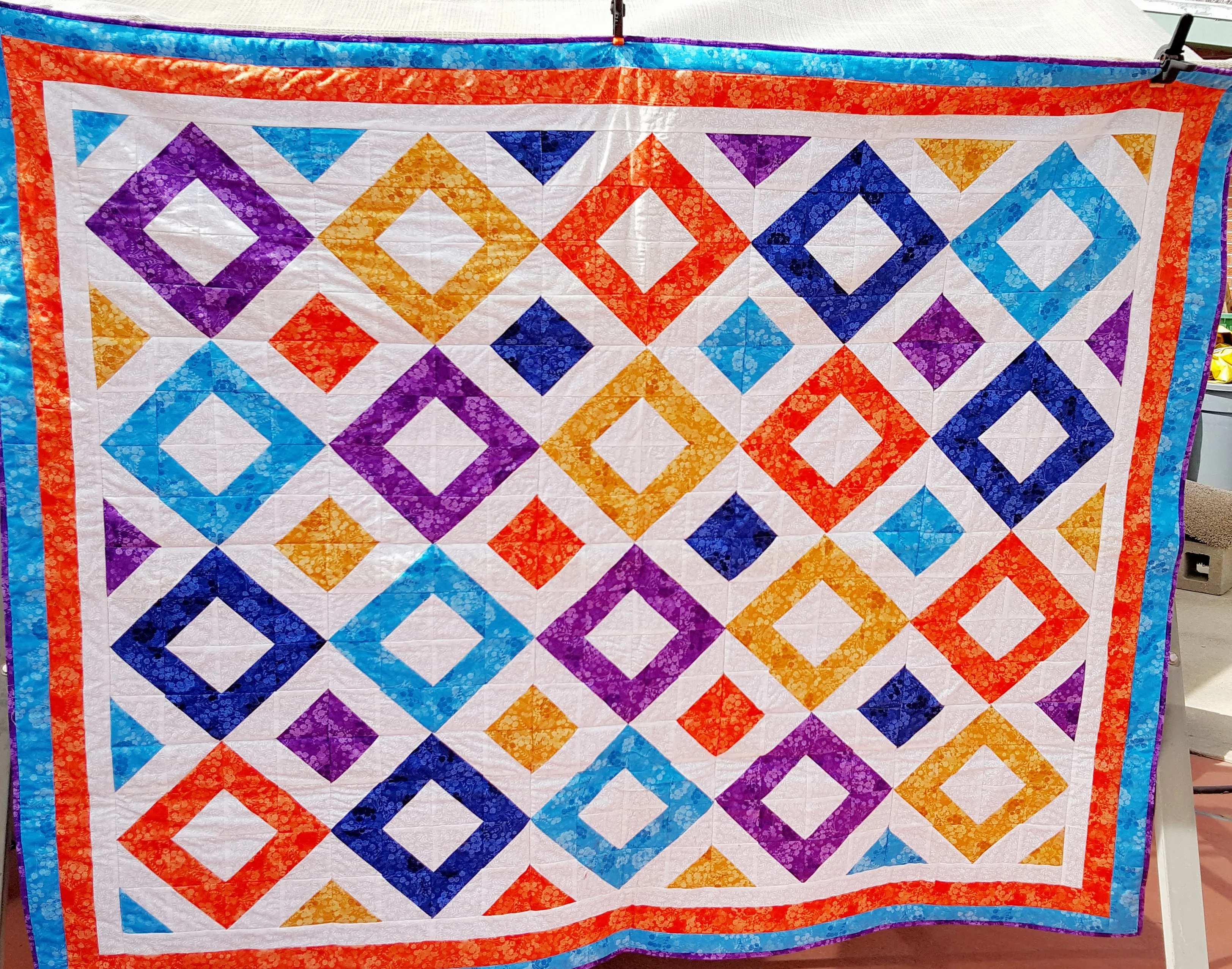 purple, red, gold and blue diamond quilt