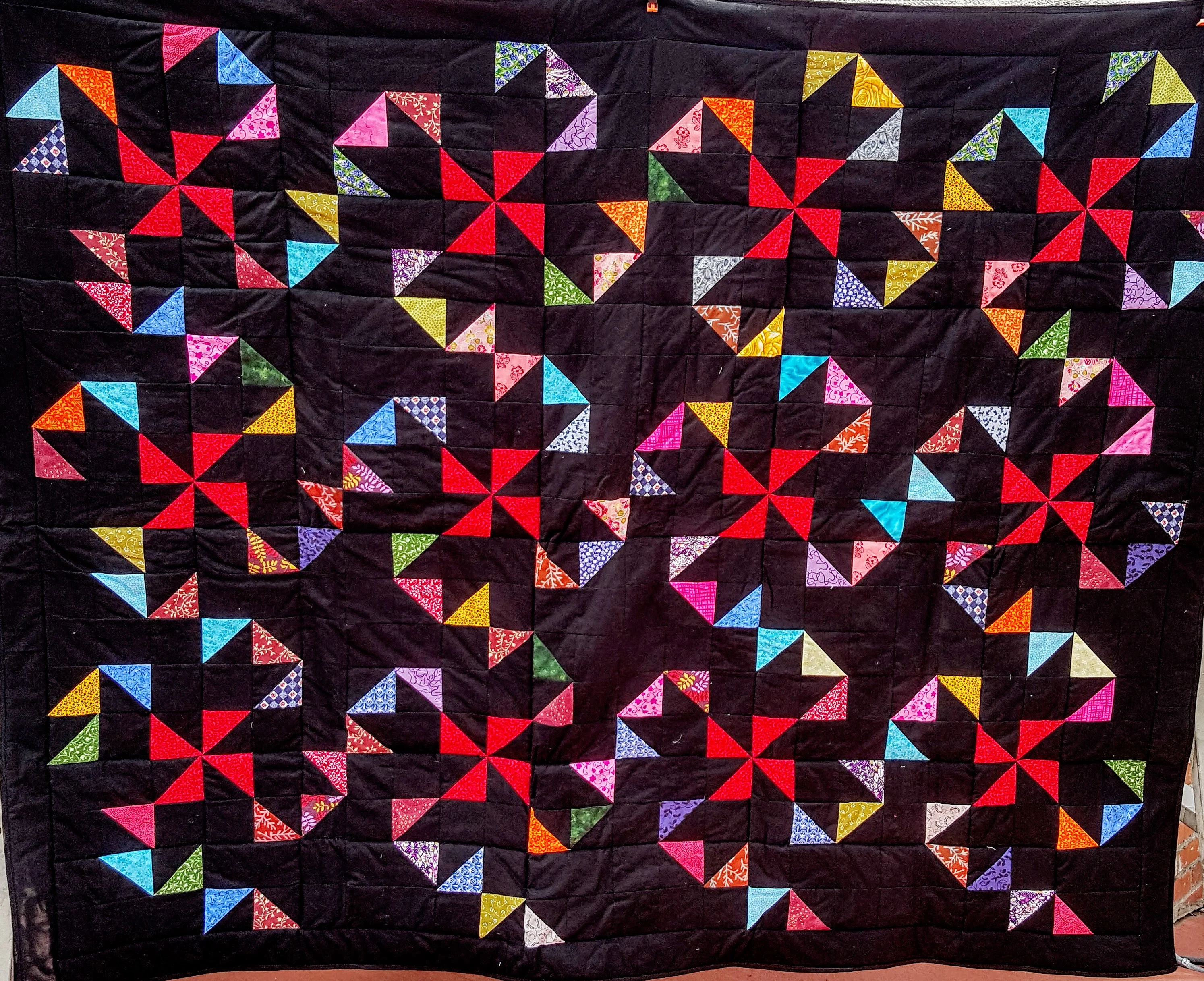 black background red pinwheels quilt